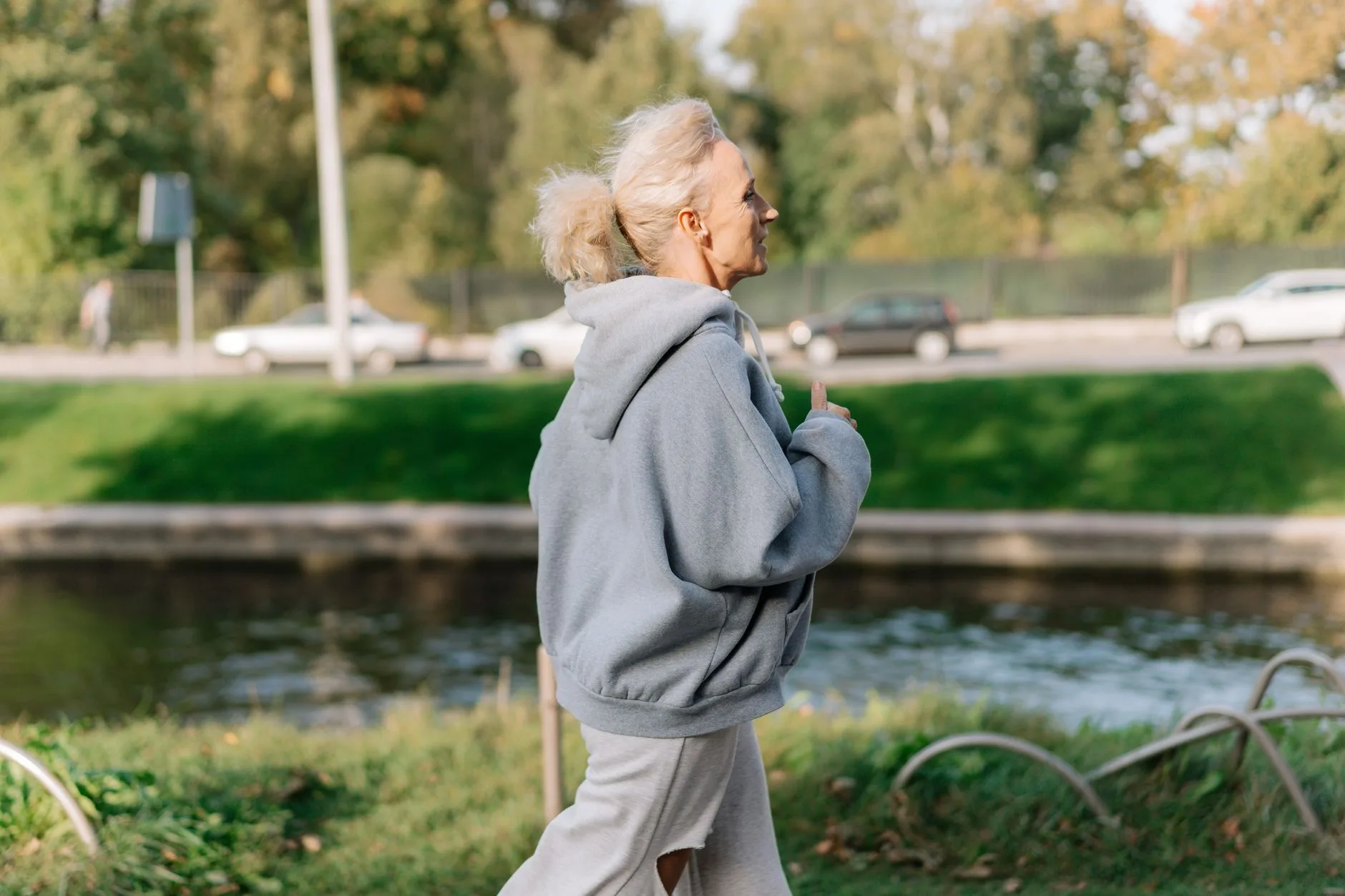 older adult jogging in park morning