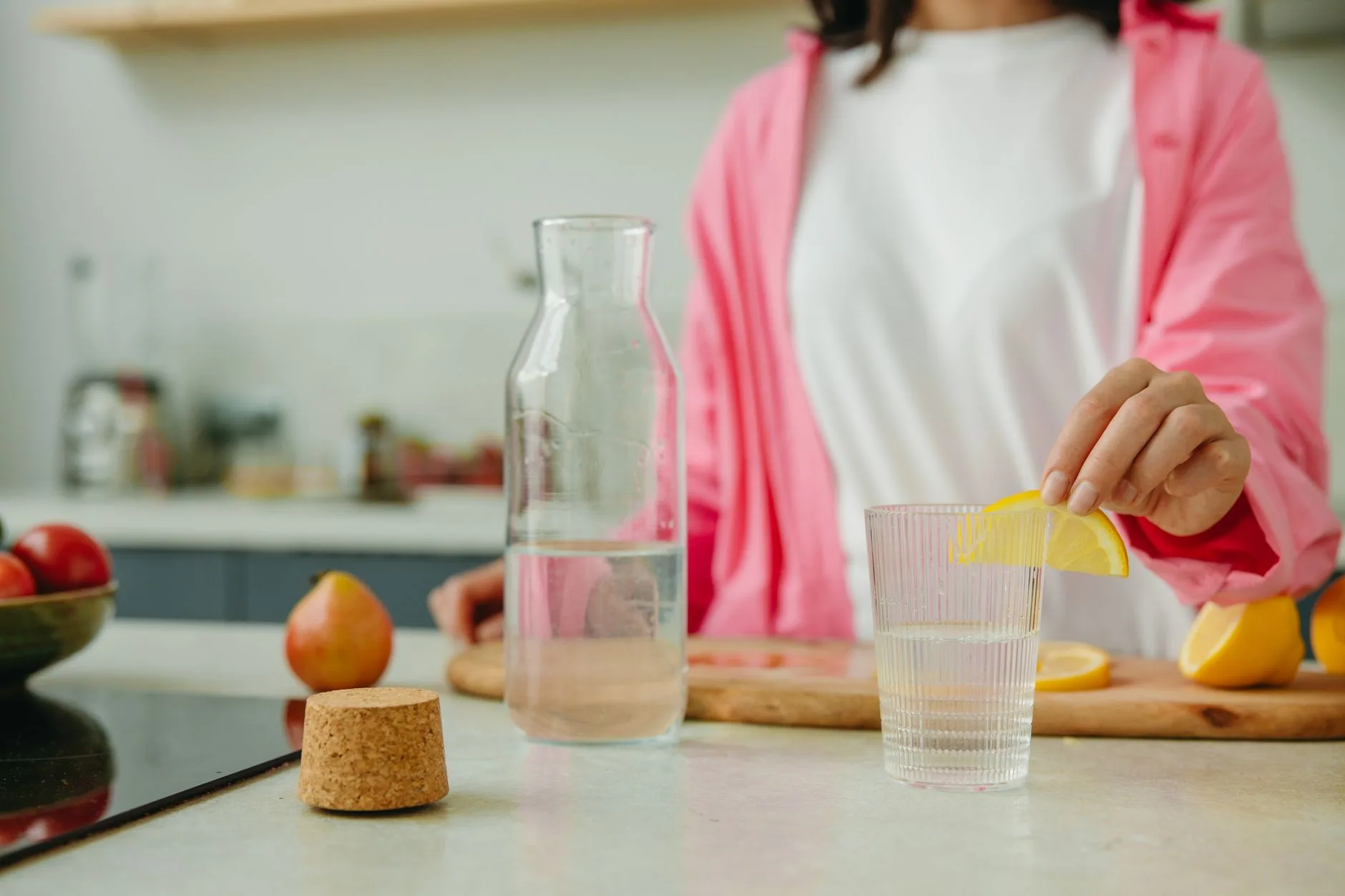 woman over 50 preparing collagen protein drink in bright kitchen