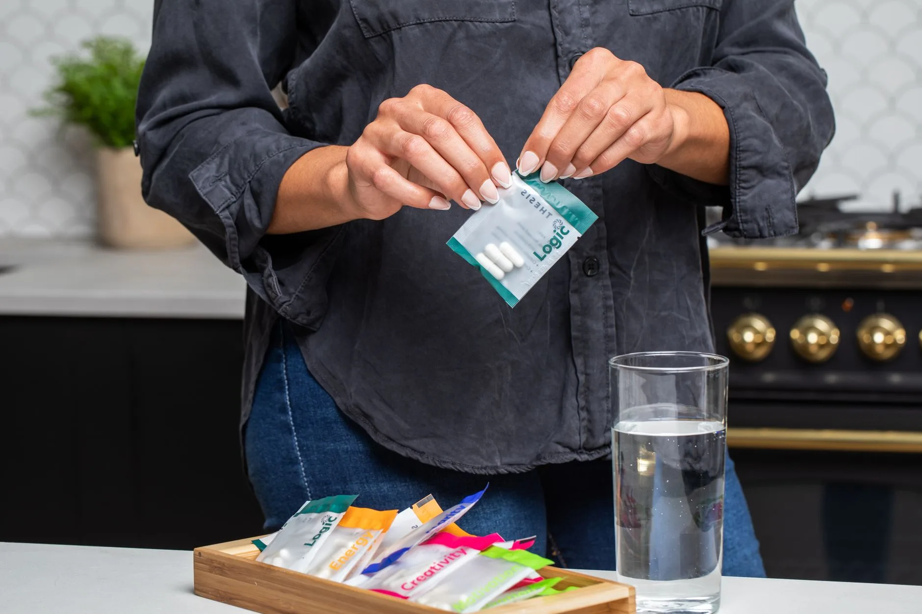 woman over 40 taking supplement capsule with water