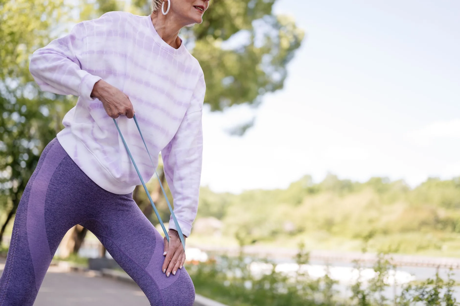 middle aged woman exercising with resistance band