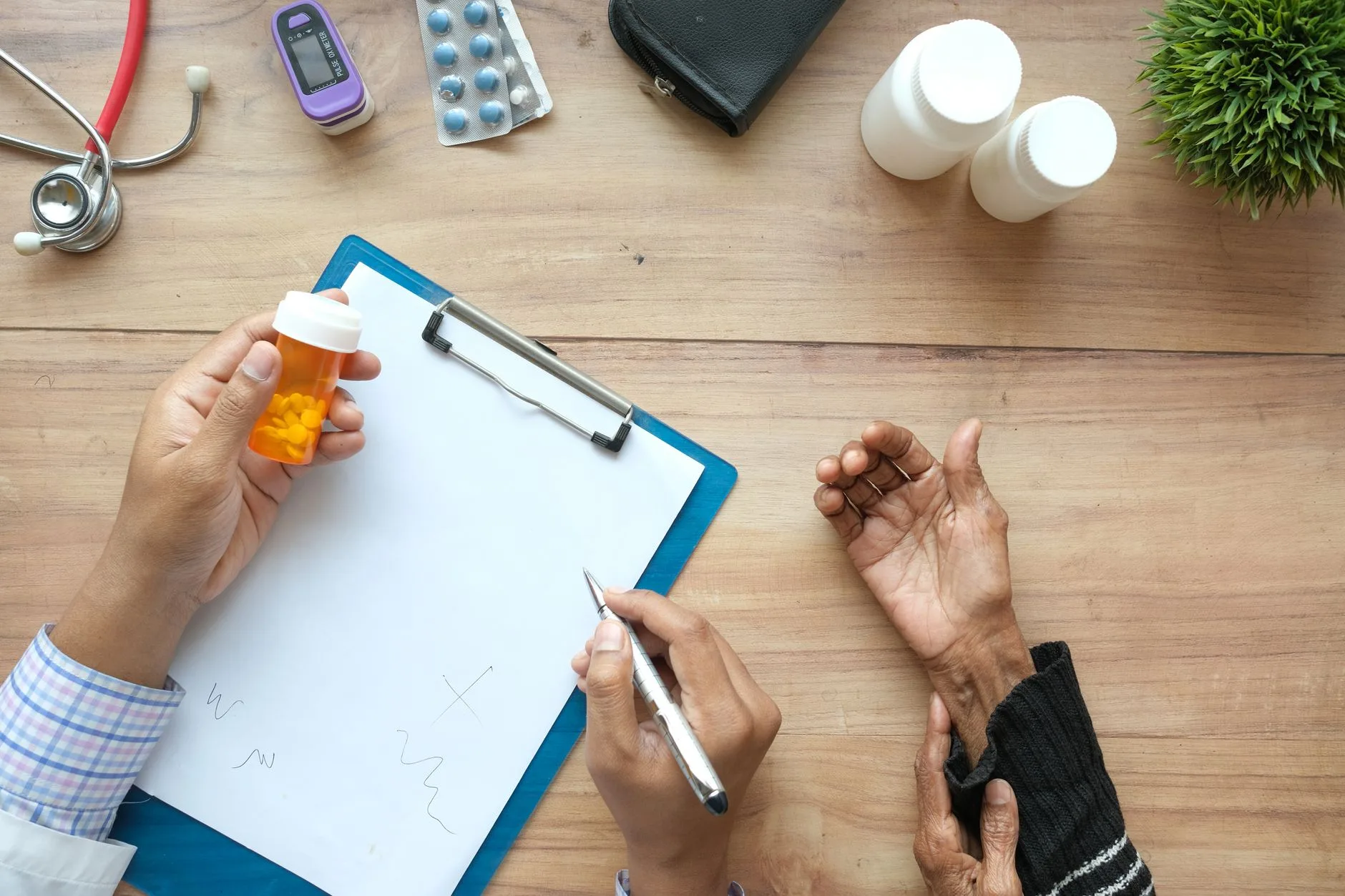 doctor discussing prescription with elderly patient