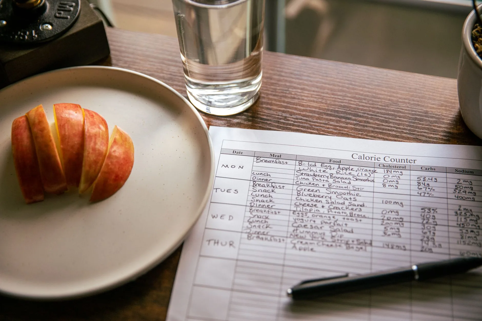 glass of water next to healthy snack on table