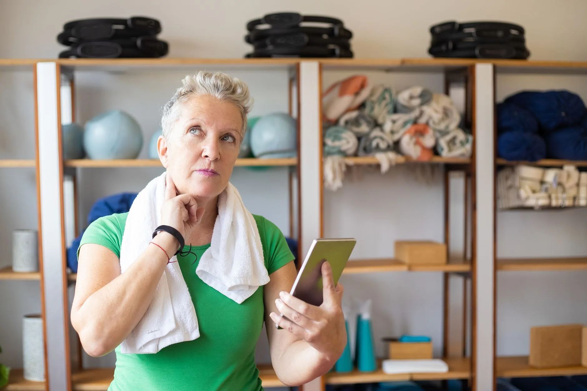 mature adult checking fitness tracker on wrist