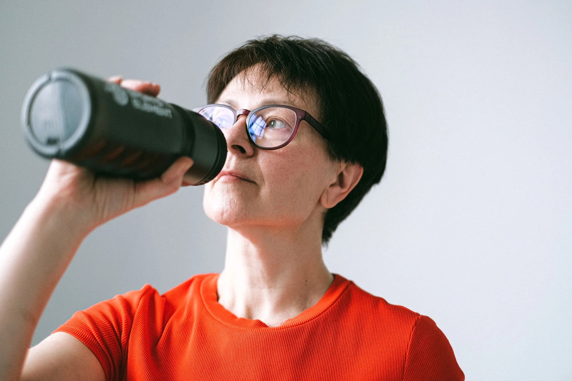 person over 40 drinking cold water in morning routine