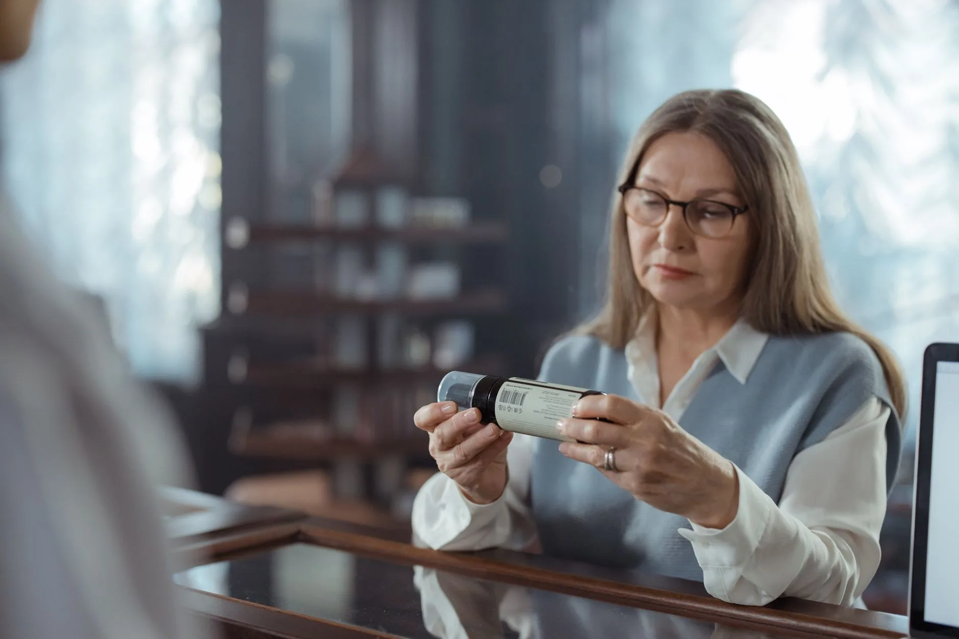 pharmacist advising older adult about supplement label