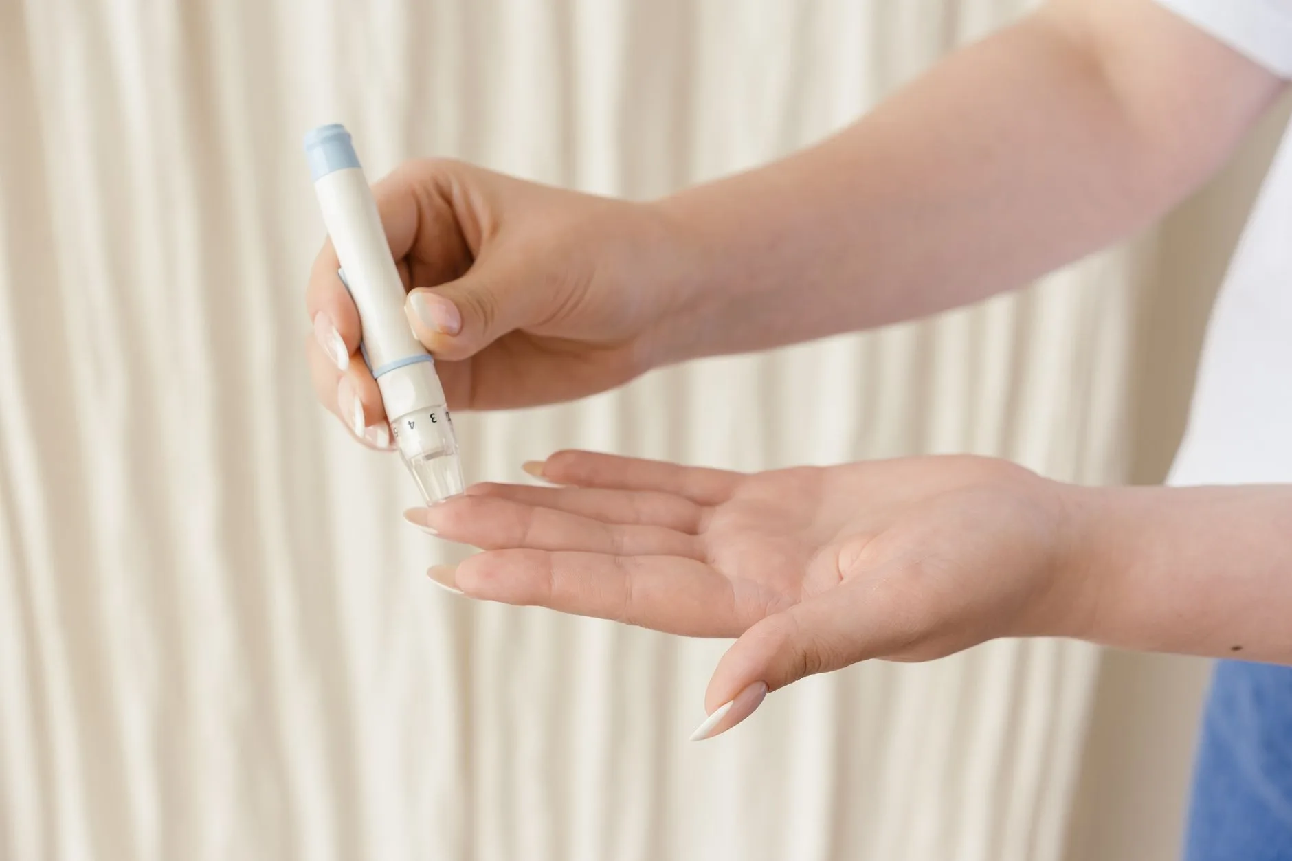 person measuring blood sugar with glucose meter fingertip