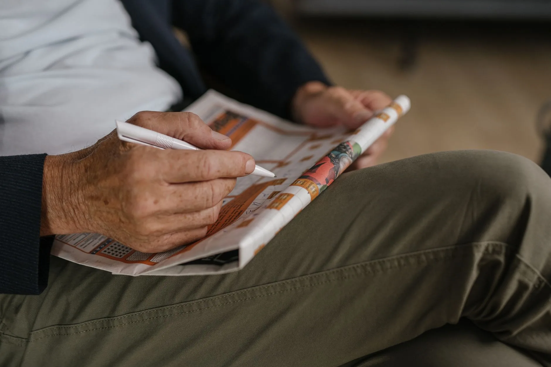older adult doing crossword puzzle