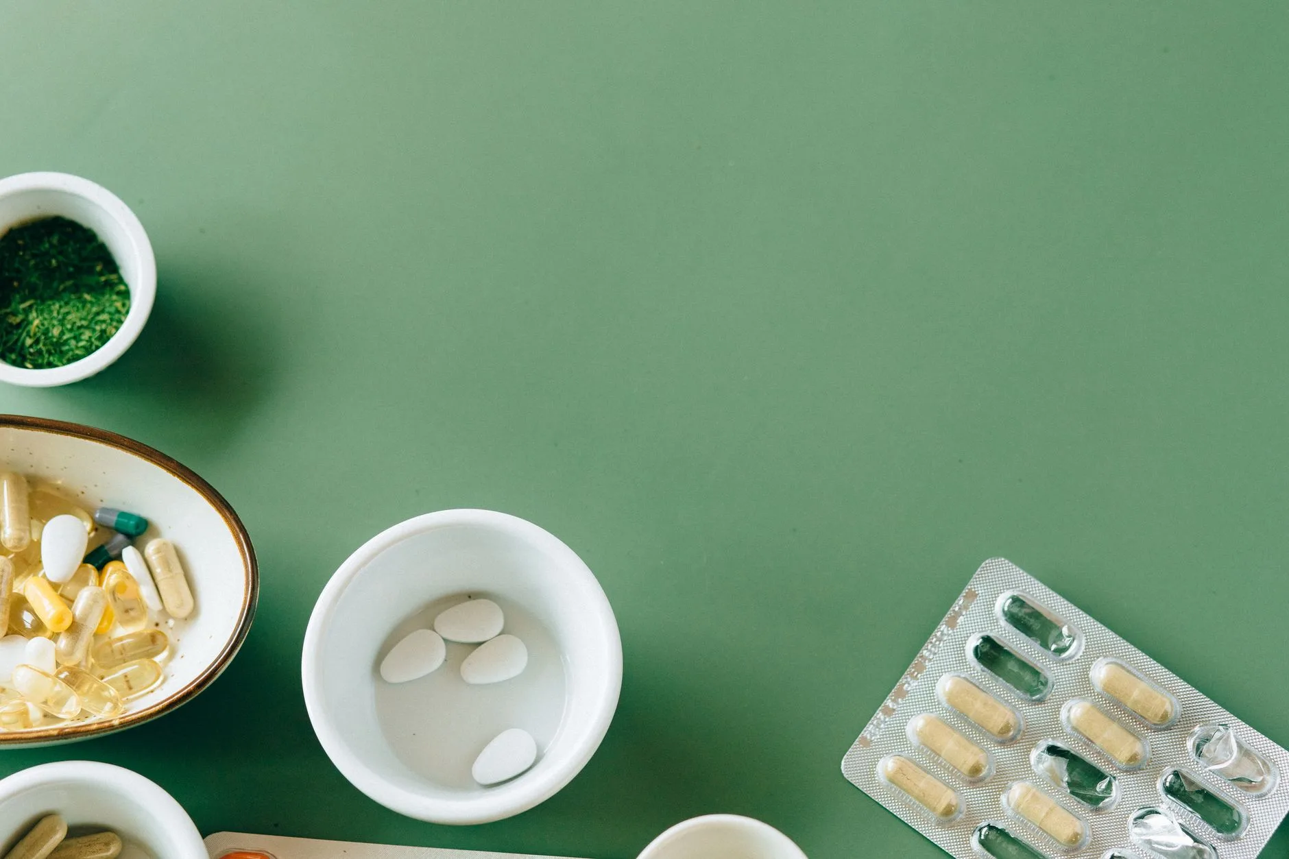 green tea extract capsules and coffee beans flat lay