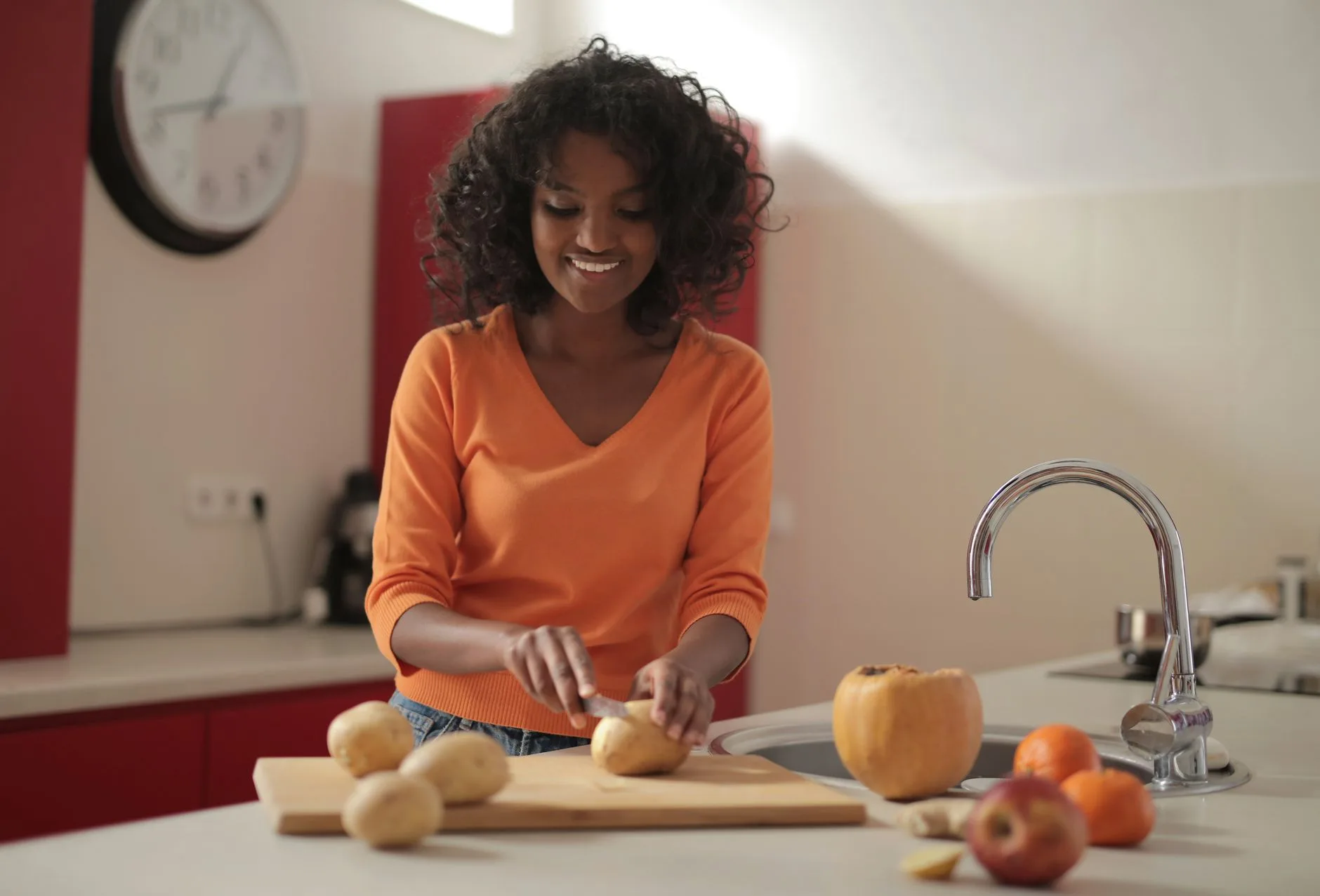 woman over 50 preparing a healthy meal in bright kitchen