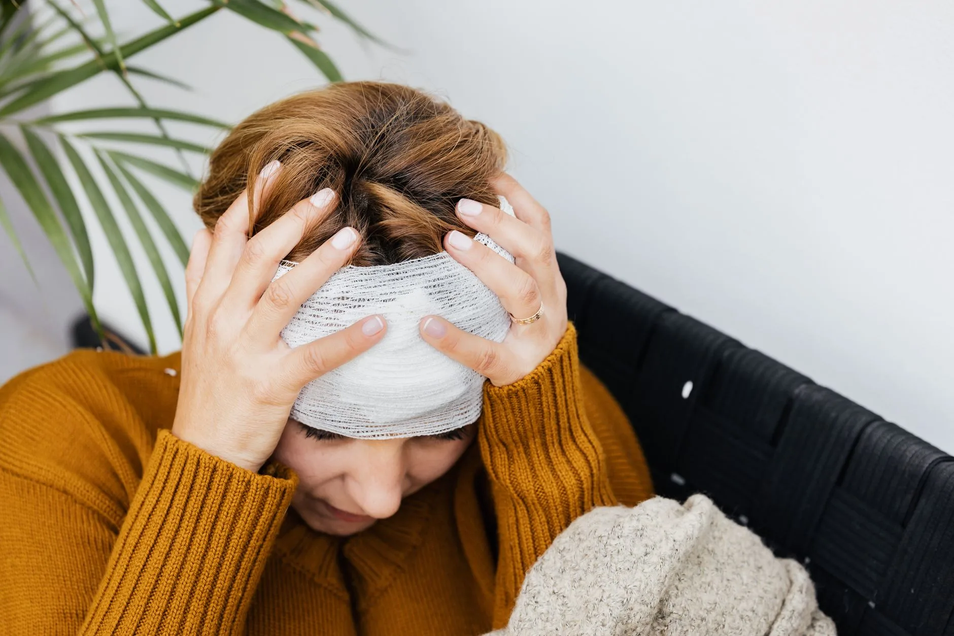 person with headache dizziness at home