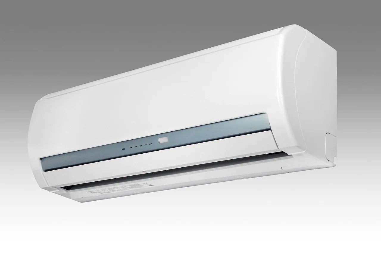 person adjusting portable 2-in-1 air conditioner control panel