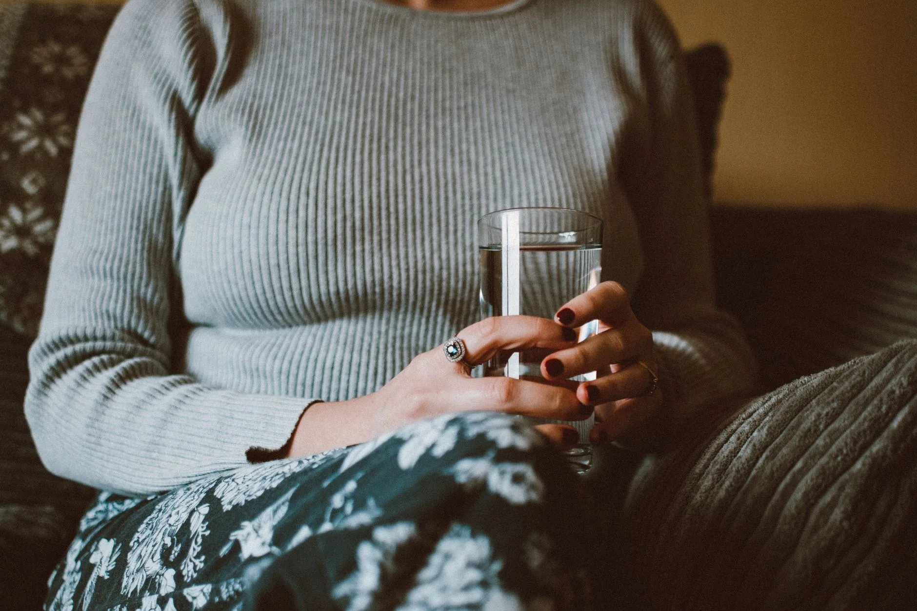 person drinking glass of water before meal