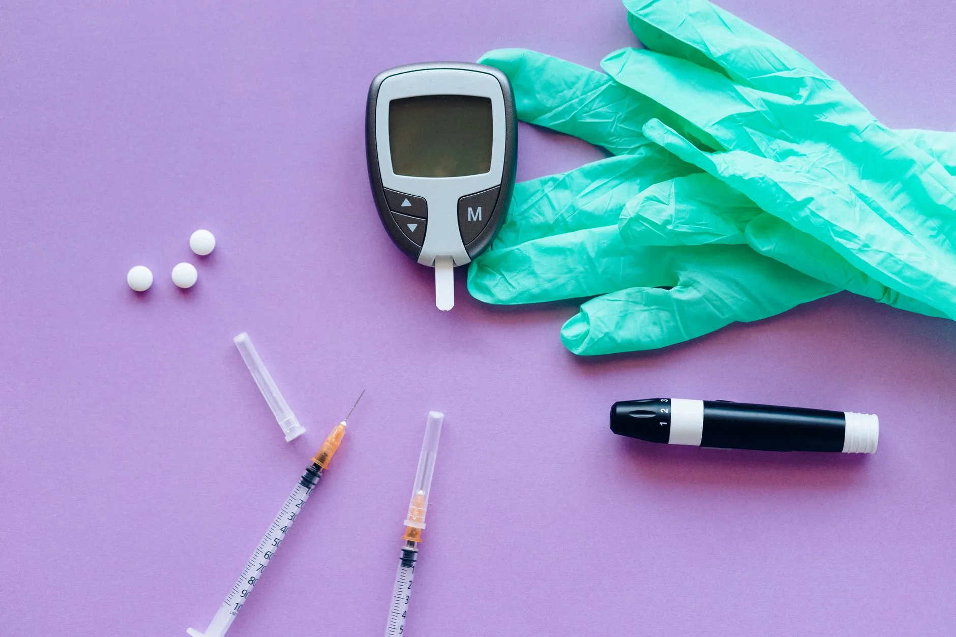 diabetes treatment FDA approved medications — assorted FDA approved diabetes medication pills and insulin pen on table