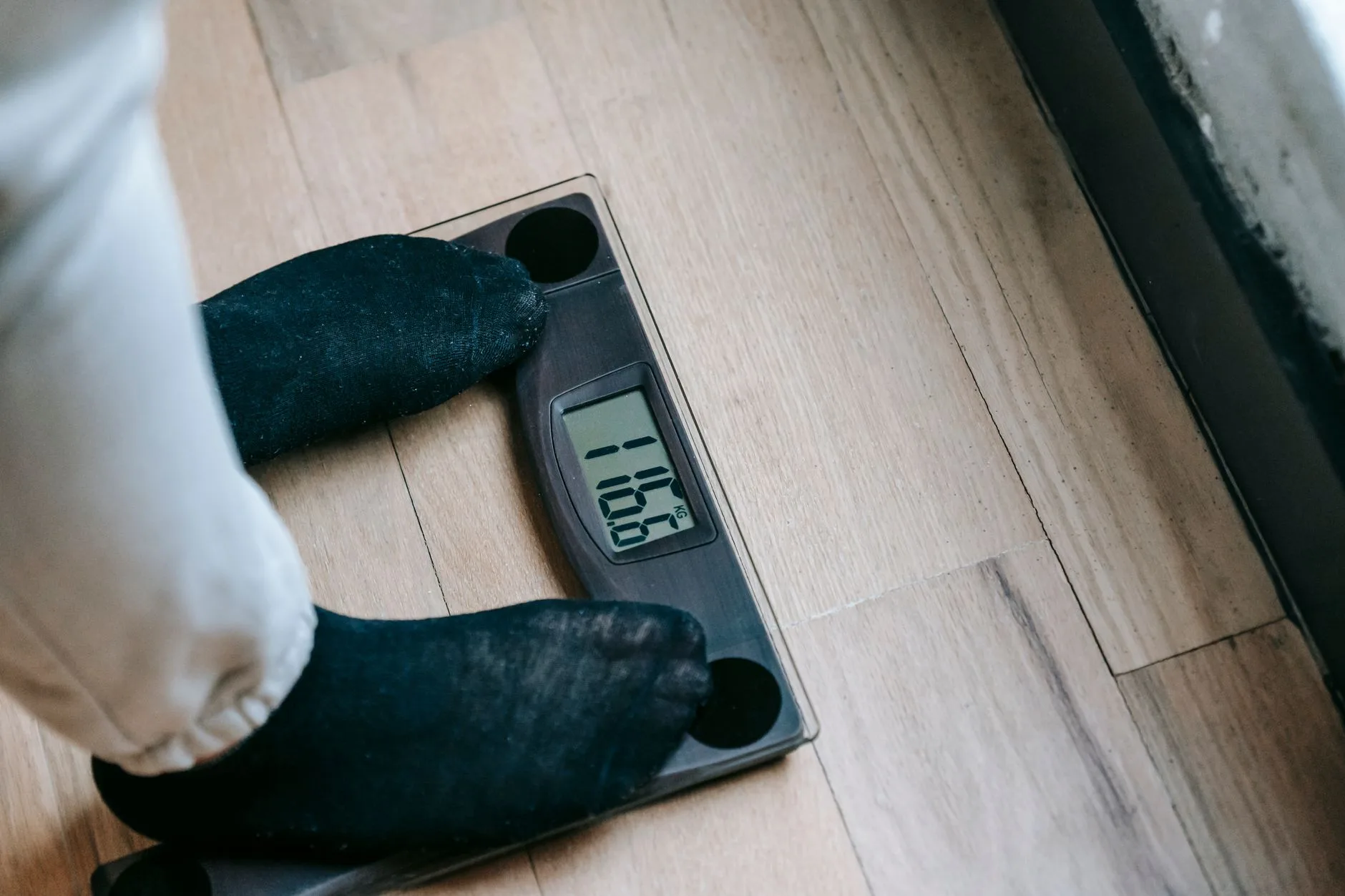 person tracking weight loss progress on a scale